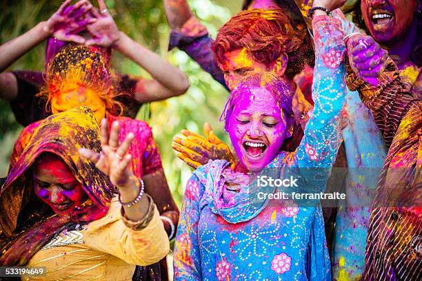Indian Friends Dancing Covered On Holi Colorful Powder In India Stock Photo - Download Image Now