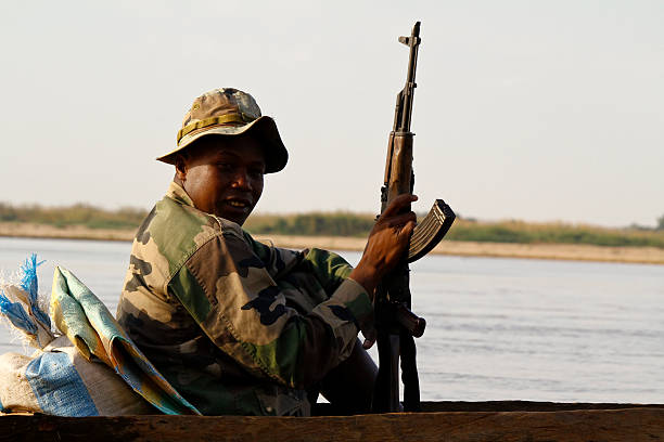 Female soldier posing in front of a white background. About 35 years old, black woman.