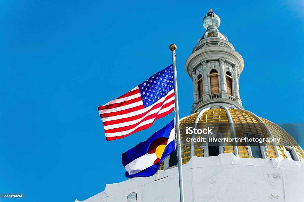 Colorado Capitol Low angle view of Colorado Capitol dome and US and Colorado flags. State Capitol Building Stock Photo
