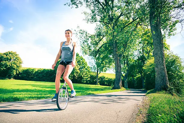 young athletic woman unicycling