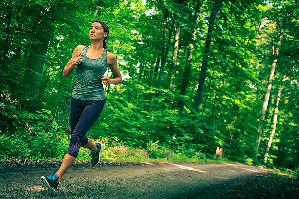 young woman jogging in the forest