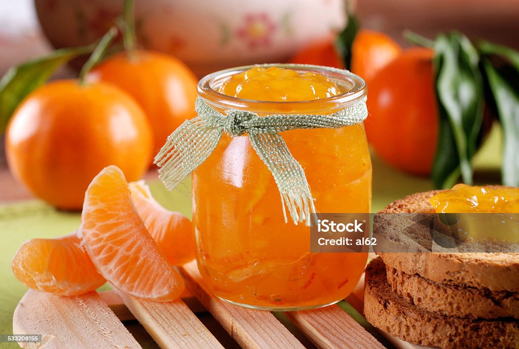 tangerine jam in glass jar tangerine jam in glass jar with fruit around 2015 Stock Photo