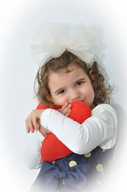 istock Young girl holding a plush red heart 533208523