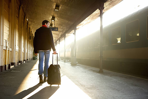 istock Young man walking with bag at train station 533208791
