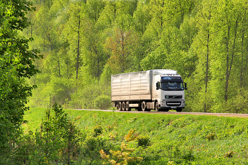 Bashkortostan, Russia - May 20, 2013: White Volvo FH12 semi-trailer truck drives at the interurban road.