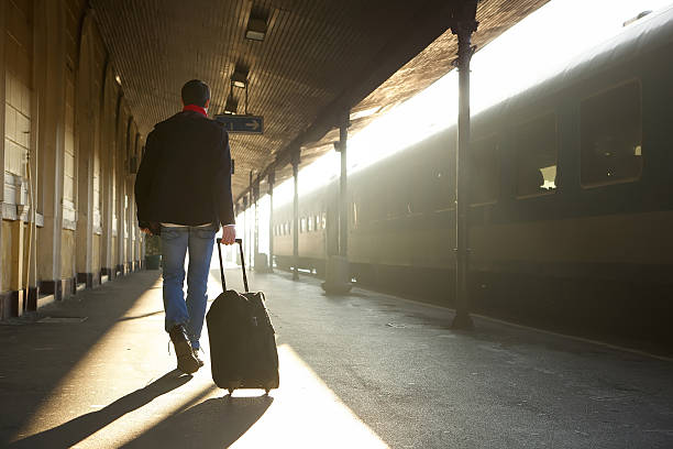 istock Man traveling with bag at train station 533209537