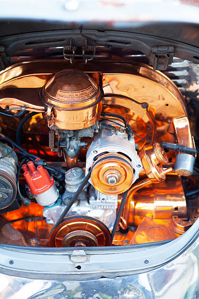 Bangkok, Thailand - January 16, 2015: Copper tuned engine of old VW Beetle oldtimer seen in Bangkok. Beetle oldtimer is standing in front of a garage restoring and selling old VW cars any kind.