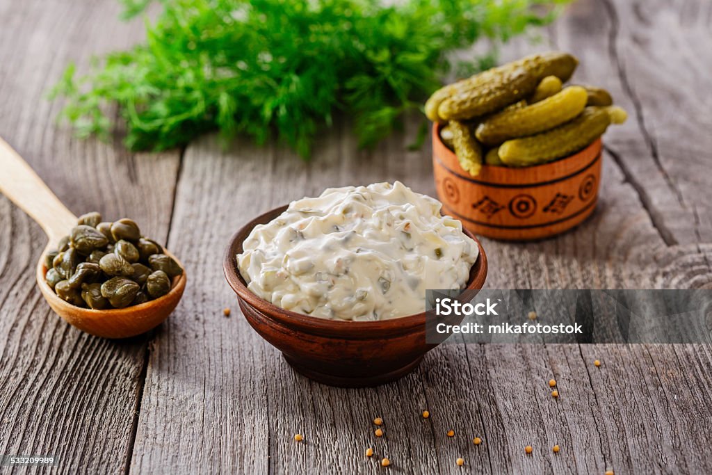tartar sauce in a gravy boat on a wooden surface 2015 Stock Photo