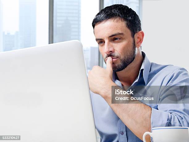 Attractive Businessman Working On Computer At Office Desk Stock Photo - Download Image Now