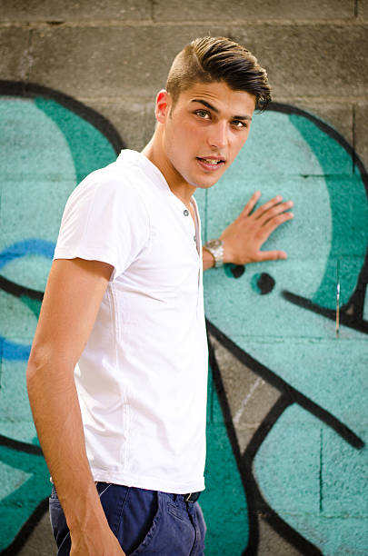 istock Attractive young man standing in front of graffiti 533211361