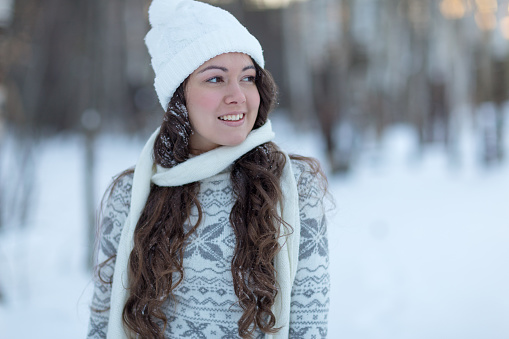 portrait of smiling girl in winter forest