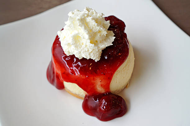istock Strawberry cheesecake with whipping cream on white plate 533213219