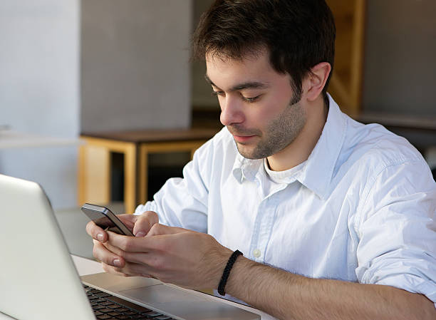 istock Young man sending text message on mobile phone 533214353