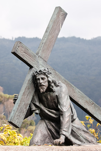 Bogota, Colombia - December 25, 2013: Christ carrying the cross. One of many bronze sculptures on the mountain of Monserrate representing the Stations of the Cross. 