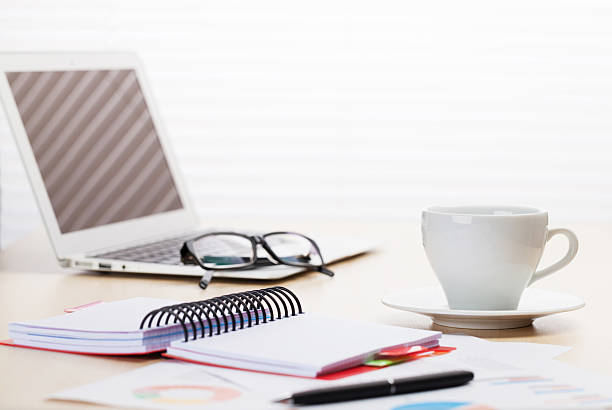 istock Office workplace with laptop, coffee and reports 533223786