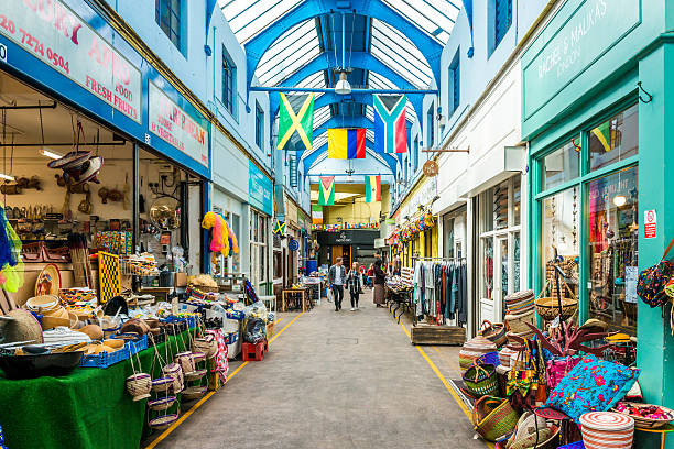 Brixton Village and Brixton Market London, United Kingdom - May 14, 2016: Brixton Village and Brixton Station Road Market. Colorful and multicultural community market run by local traders in South London. brixton stock pictures, royalty-free photos & images