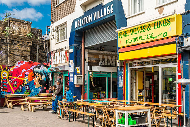 Brixton Village and Brixton Market London, United Kingdom - May 14, 2016: Brixton Village and Brixton Station Road Market. Colorful and multicultural community market run by local traders in South London. brixton stock pictures, royalty-free photos & images