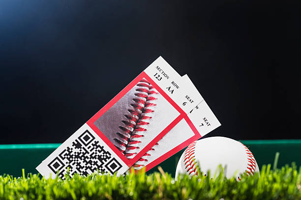 istock Baseball night game ticket stubs in outfield grass with ball 533225290