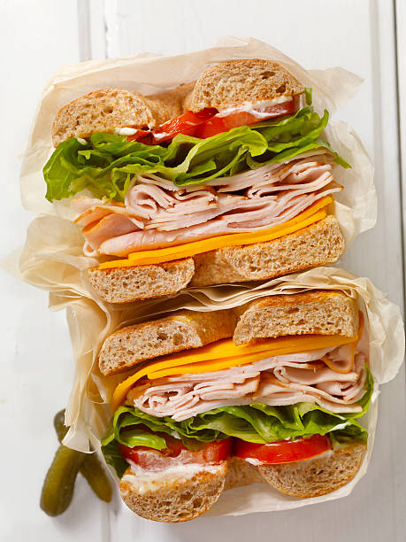 Deli Style Turkey Bagel Sandwich Deli Style Turkey Bagel Sandwich with Cheddar Cheese, Lettuce,Tomato and Mayo - Photographed on a Hasselblad H3D11-39 megapixel Camera System mayonnaise photos stock pictures, royalty-free photos & images