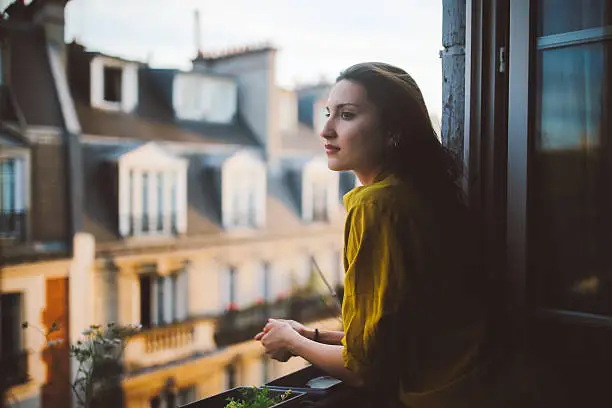 Photo of Young woman relaxing on the balcony of her Montmartre apartment