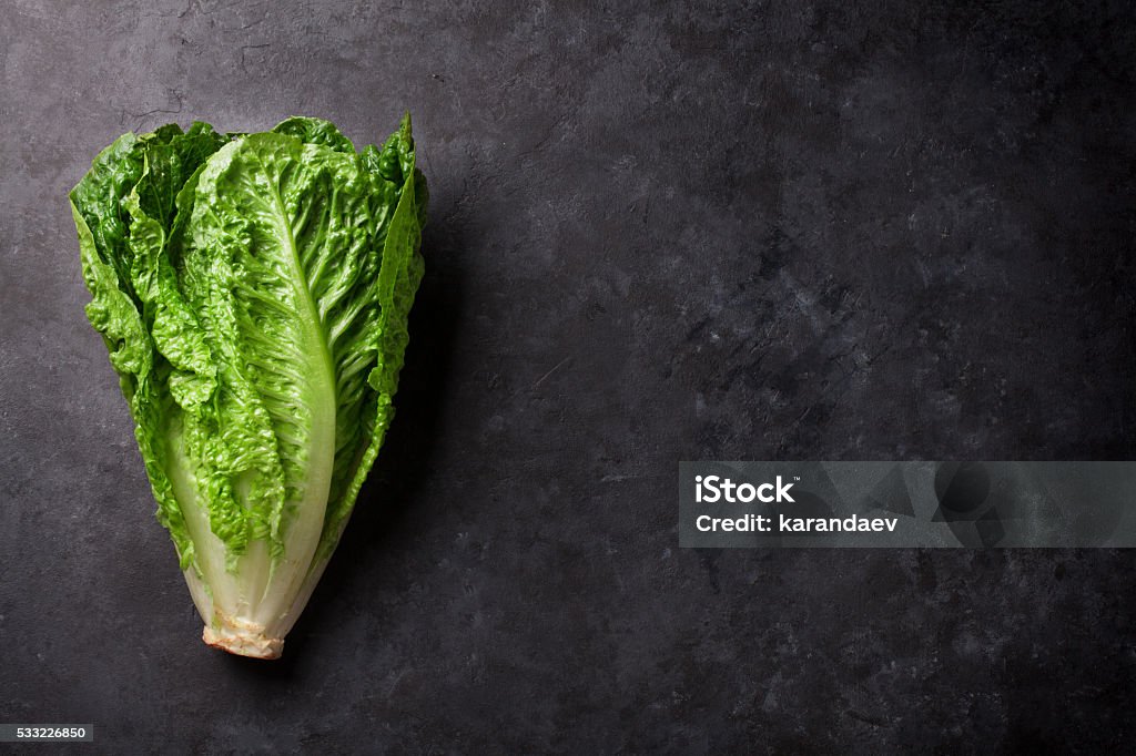 Romaine lettuce salad Romaine lettuce salad over stone table. Top view with copy space Romaine Lettuce Stock Photo