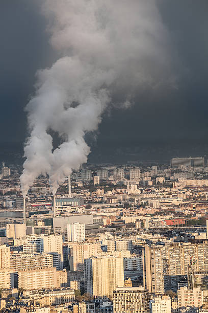 istock smoking factory chimneys over evening Paris suburbs with gathering storm 533226908