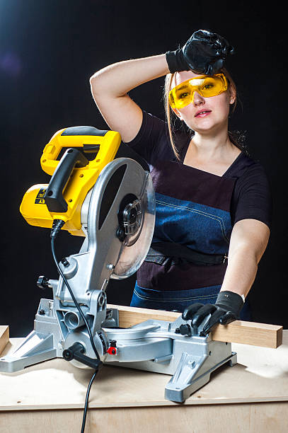 istock Tired female carpenter with a circular disk saw 533227226