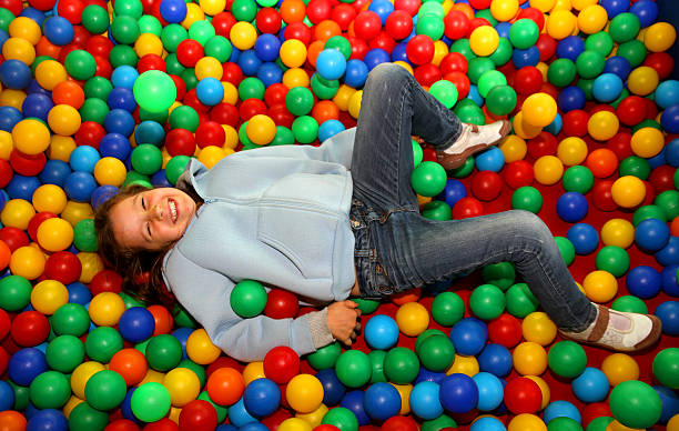 istock nice little girl playing in the pool with plastic balls 533227237
