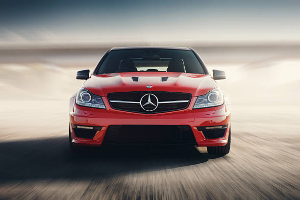 Red Sport Car Drive Speed On Asphalt Road At Sunset Saratov, Russia - August 24, 2014: Mercedes-Benz C63 AMG car drive on road at sunset mercedes benz photos stock pictures, royalty-free photos & images