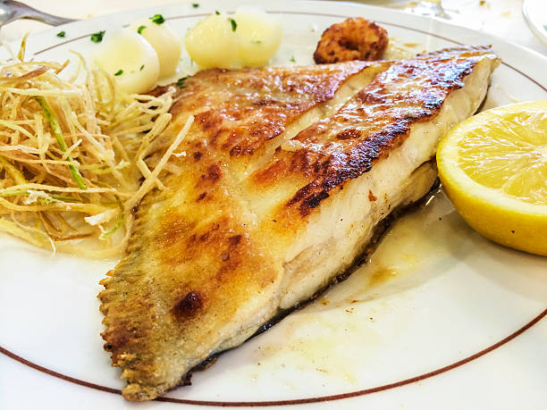 Grilled turbot Grilled turbot on plate with lemon turbot stock pictures, royalty-free photos & images