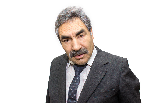 Portrait of shocked businessman over colored background. Shocked businessman looking at camera with negative, worried facial expression. Horizontal composition. Frustrated businessman has got white hair, mustache. Studio shot.