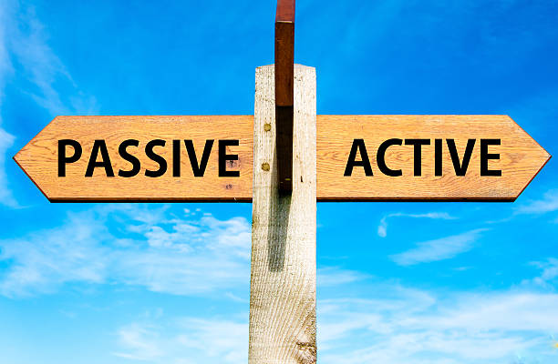 Passive versus Active messages, Lifestyle change conceptual image Wooden signpost with two opposite arrows over clear blue sky, Passive versus Active messages, Lifestyle change conceptual image serene people stock pictures, royalty-free photos & images