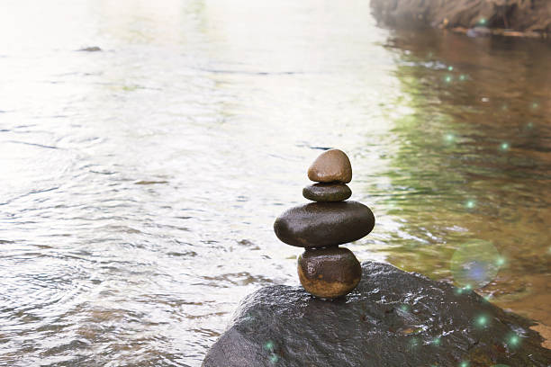 istock Superimposed waterfall pebble rock arranged on big stone 533231068