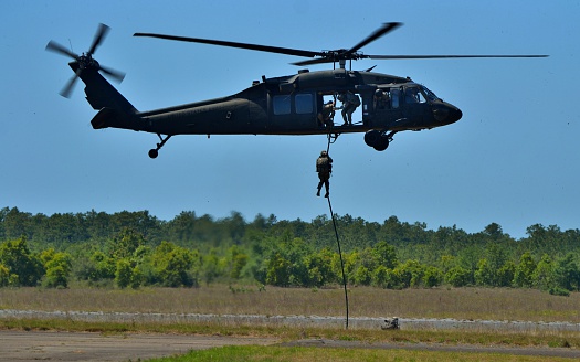 Camp Rudder, FL, USA - May 7, 2016: A Sikorsky UH-60 Blackhawk operated by the U.S. Army Rangers flying a training sortie at Camp Rudder in the Florida Panhandle. 