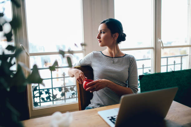 Young freelancer woman working in her Parisian apartment