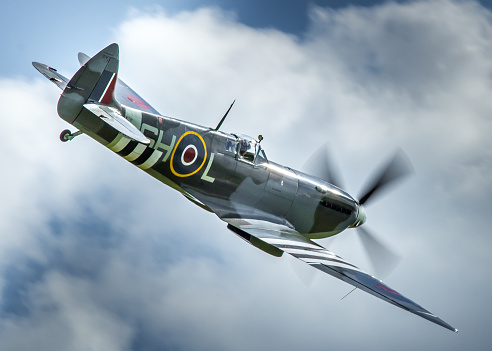 Duxford, UK - May 25, 2014: a Spitfire LF.IXc WWII British fighter aircraft in flight over an airfield in Cambridgeshire, England. 