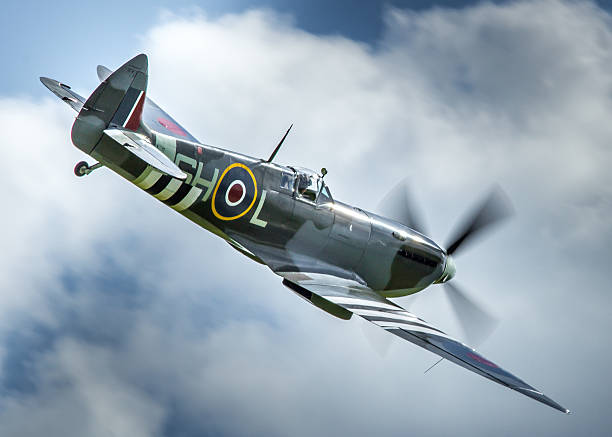 Spitfire MK912 in flight Duxford, UK - May 25, 2014: a Spitfire LF.IXc WWII British fighter aircraft in flight over an airfield in Cambridgeshire, England.  kent england photos stock pictures, royalty-free photos & images
