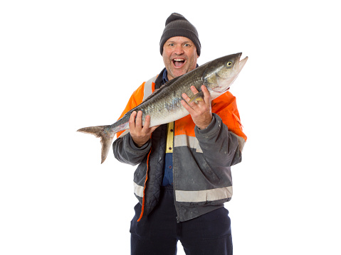 A man showing his catch with an excited expression. Isolated on white.