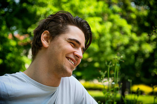 istock Attractive young man smiling in nature environment 533240613