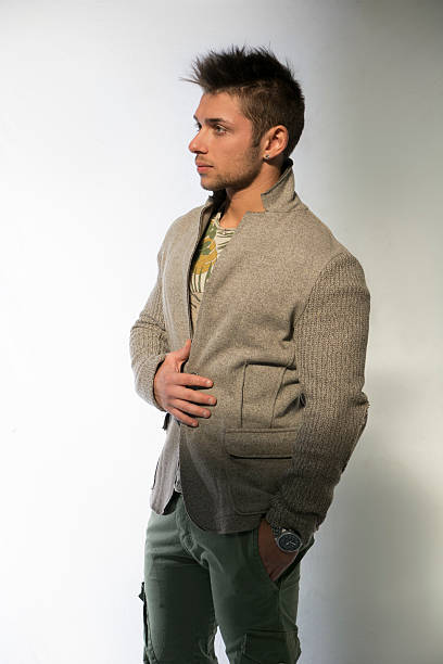 istock Handsome young man with wool sweater on light background 533240693