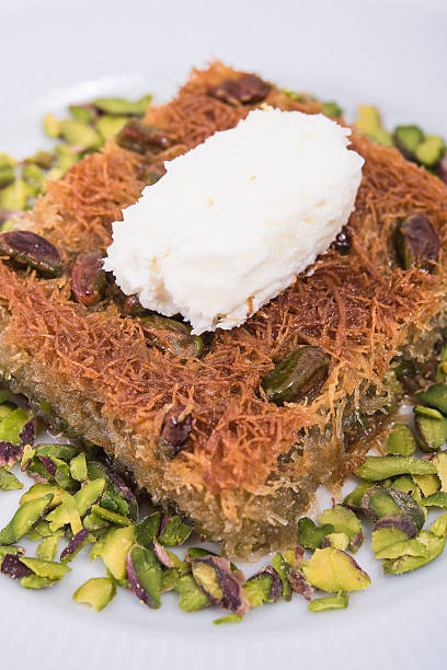kadayif dessert with cream and pistachio stock photo