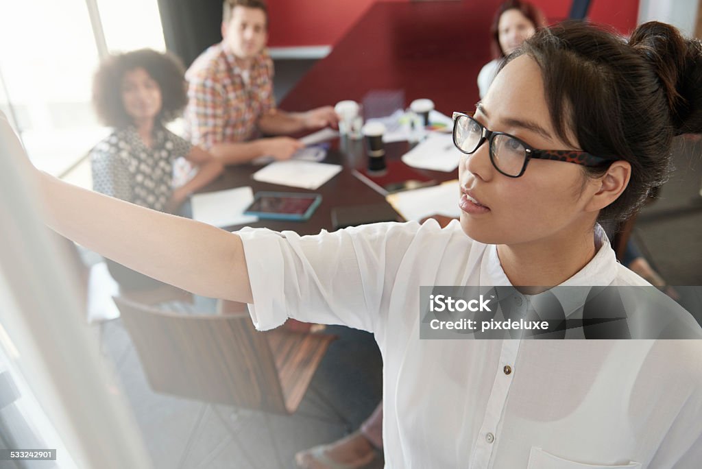 In the planning stages of their project Shot of an attractive young businesswoman leading a brainstorming session during a meeting 2015 Stock Photo