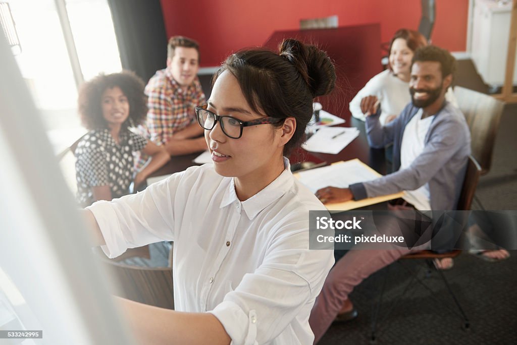 She's in charge on this project Shot of an attractive young businesswoman leading a brainstorming session during a meeting 2015 Stock Photo