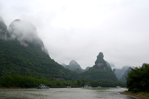 Cruise boats sailing along the beautiful Li river's karst scenery. It ranges 83 kilometers from Guilin to Yangshuo, where the Karst mountain and river sights highlight the famous Li River cruise.