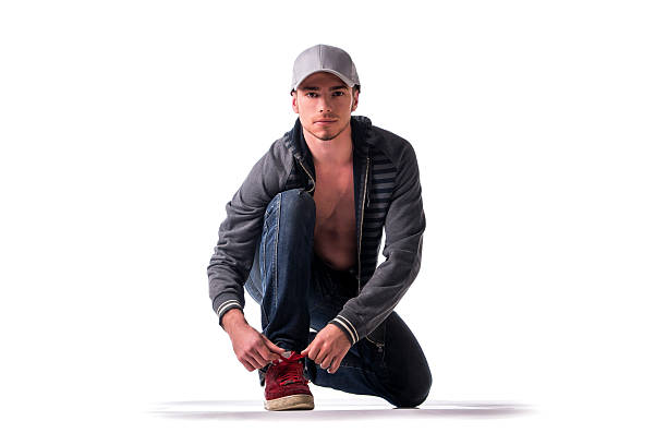 istock Handsome young man kneeling and tying sneaker 533244491