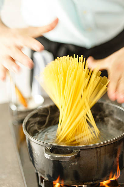istock Spaghetti being put into a pan of boiling water 533245442