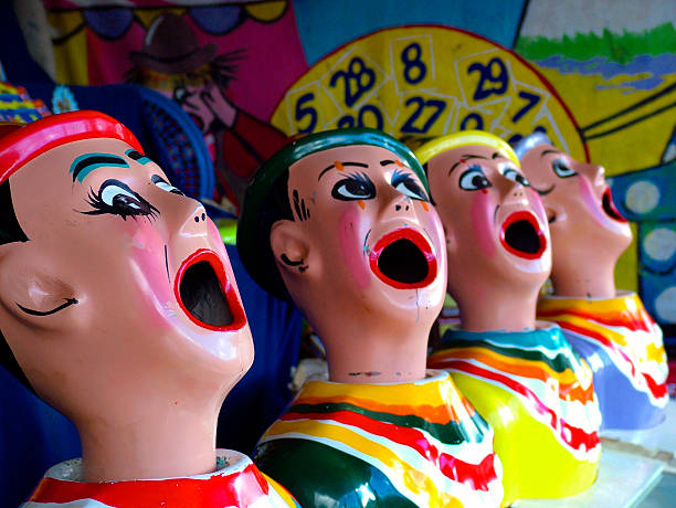 istock Carnival clowns with open mouths at a funfair 533245999