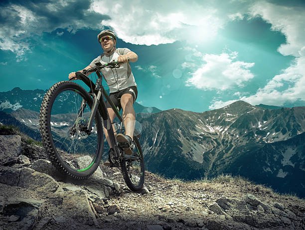 istock Man stay on the bicycle under sky with clouds 533246752