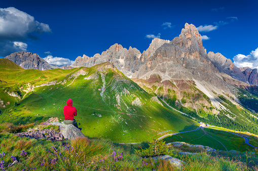 Climber admiring of the landscape of Pale di San Martino, Trentino - Dolomites, Italy. Cimon della Pala mountain ridge.