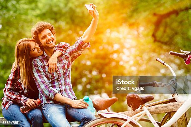 Young Couple Making Selfie After Riding Bicycle Outdoors Stock Photo - Download Image Now